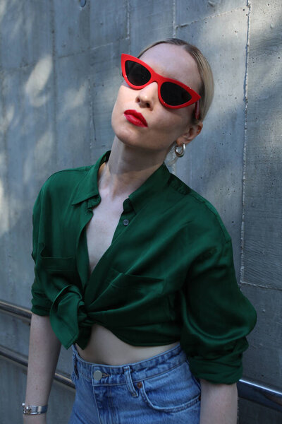 Young hipster girl wears retro sunglasses, posing outdoor. Lifestyle concept.