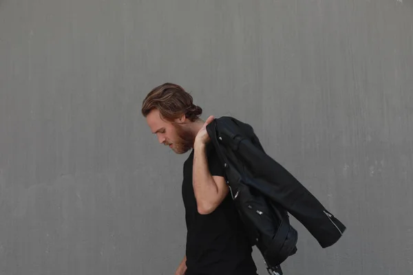Jeune homme hipster posant en extérieur portant une veste en cuir. Espace pour le texte. — Photo