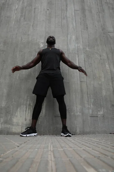 Sporty Černoch mladý muž dělá tvrdé cvičení venku. Svislý portrét. — Stock fotografie