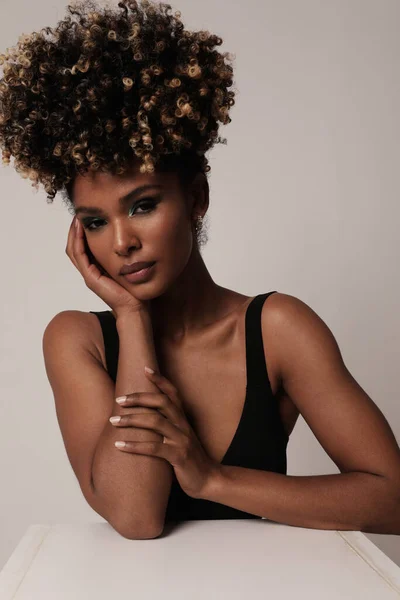 Beautiful African American woman with curly hair posing on white. Vertical. — Stock Photo, Image