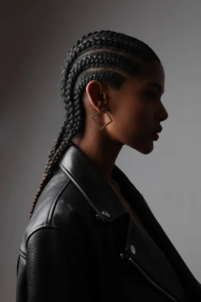 Vertical headshot of African young woman with braids posing on grey wall. — Foto de Stock