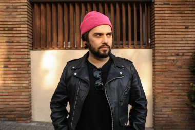 Deri ceketli ve bereli sakallı hippi. Açık hava..