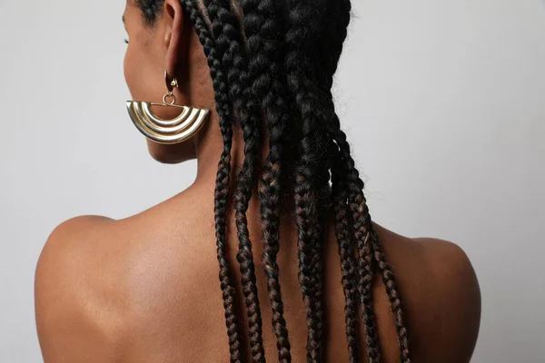 Close-up of African young woman with dark braids posing on white background. — стоковое фото