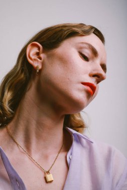 Parlak makyajlı, altın mücevher takan muhteşem bir kadının yan portresi.. 