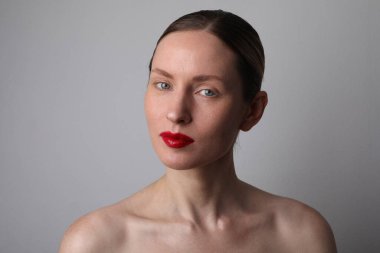 Beauty face. Caucasian woman with glowing skin and natural makeup at studio. 