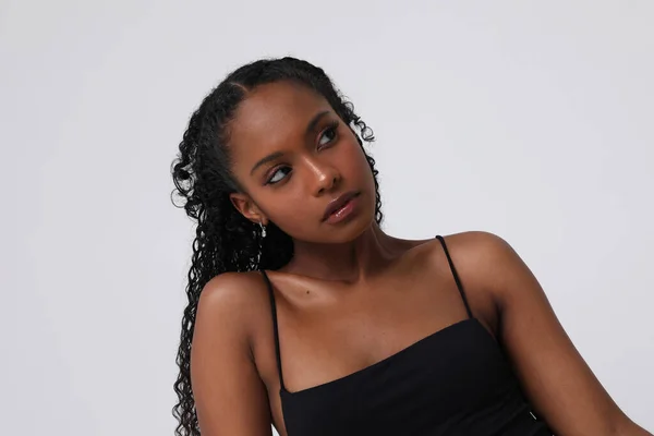 Portrait of confident African American young woman posing indoors. Isolated. — Stock Photo, Image