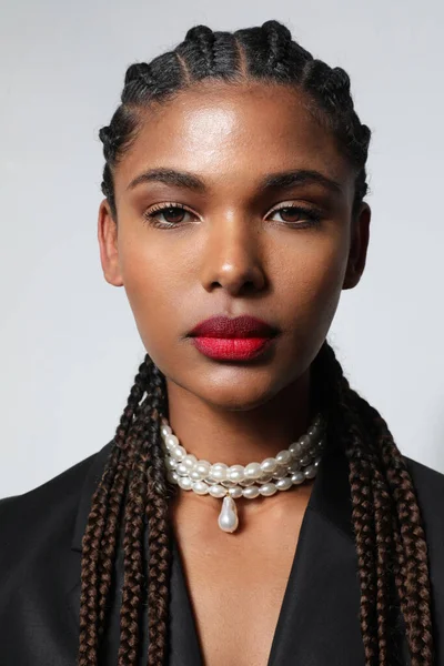 Portrait of African American woman with long braids wears pearls necklace. — Foto de Stock