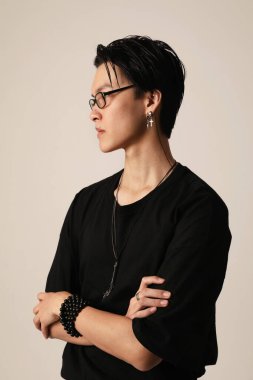 Beyaz arka planda poz veren kendine güvenen Asyalı genç bir adam. Dikey. Yüksek kalite fotoğraf.