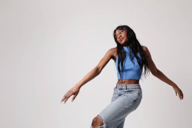 Genç Afrikalı Amerikalı kadın, günlük giysiler giyip kameraya bakıyor. Yüksek kalite fotoğraf.