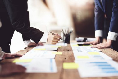 Beyin Fırtınası, Danışmanlık, Veri Analizi, Planlama, Pazarlama ve Muhasebe, Ekonomist, Yatırım belgelerine işaret eden bir kalem tutuyor..