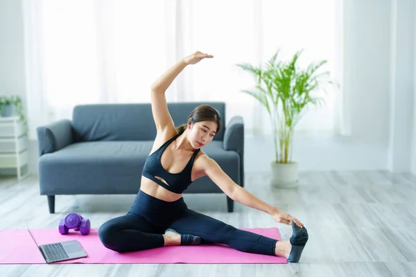 Stress relief, muscle relaxation, breathing exercises, exercise, meditation, portrait of Young Asian woman relaxing her body from office work by practicing yoga by watching online tutorials. — Stockfoto