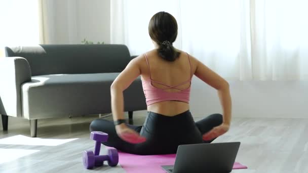 Stress relief, muscle relaxation, breathing exercises, exercise, meditation, portrait of Young Asian woman relaxing her body from office work by practicing yoga by watching online tutorials — Vídeo de stock