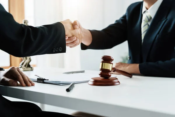 Law, consultation, agreement, contract, lawyer or attorney shakes hands to agree on the clients offer to be hired to fight the parties in court. — Stockfoto