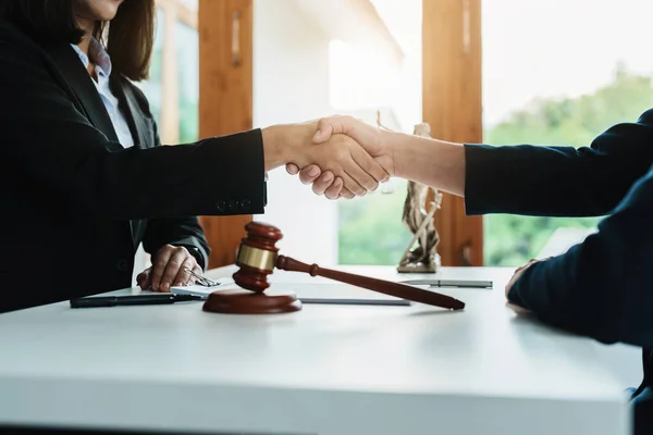 Law, consultation, agreement, contract, lawyer or attorney shakes hands to agree on the clients offer to be hired to fight the parties in court. — Stockfoto