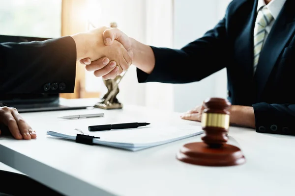 Law, consultation, agreement, contract, lawyer or attorney shakes hands to agree on the clients offer to be hired to fight the parties in court. — Stockfoto