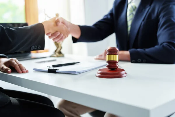 Law, consultation, agreement, contract, lawyer or attorney shakes hands to agree on the clients offer to be hired to fight the parties in court. — Stockfoto