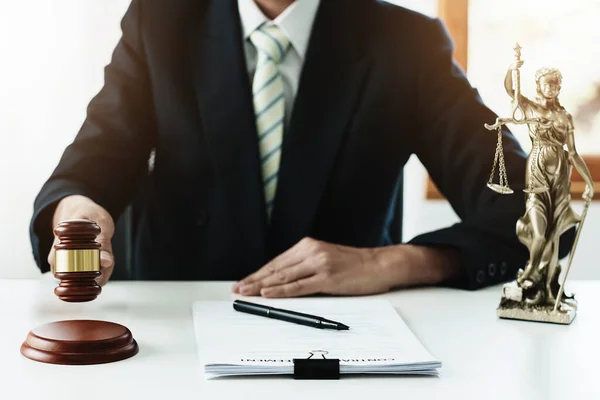 Law, Consultation, Agreement, Contract, Concept Attorney or lawyer focusing on the court hammer is sitting on the chair with a clients complaint to determine the house and land in court — Stockfoto