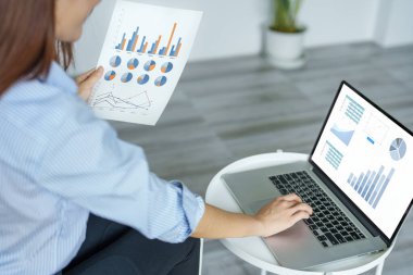 self employed, business owner, pleasure from work, Asian woman using computer holding financial documents to check or plan budget, manage investment risk at home