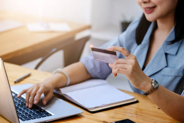 Online Shopping and Internet Payments, Beautiful Asian women are using their credit cards and computer laptop to shop online or conduct errands in the digital world
