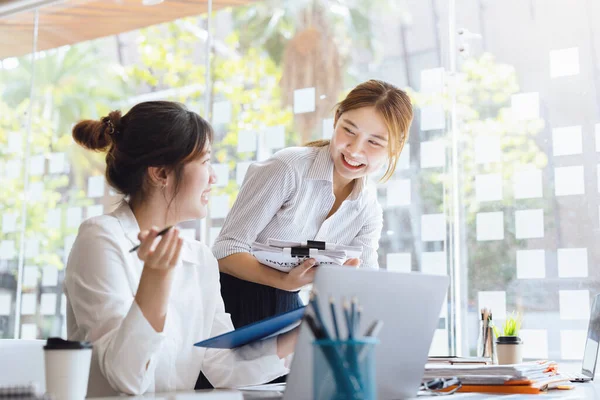 Negotiation, Analysis, Discussion: Portrait of an Asian woman economist and marketer pointing to a financial data sheet to plan investments to prevent risks and losses for the company.