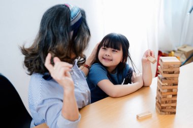 Asyalı portre, torun torun büyükanne, büyükanne ve torun mutlu bir şekilde ağaç oyunu bulmaca ve torunların yeteneklerini geliştirme etkinliklerine katılıyor..
