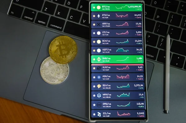 Mobile at on computer, launching program for trading cryptocurrency.