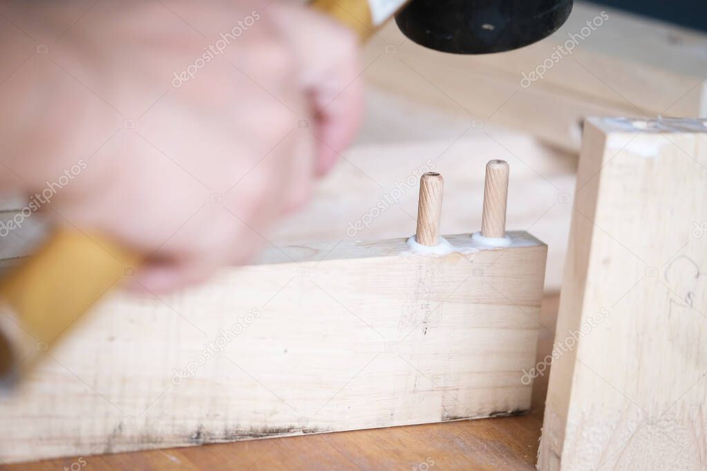 Focus on the woodwork, Entrepreneur Woodwork holding hammer to assemble the wood pieces as the customer ordered.