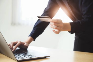 Online payment, Young Womens hands holding credit card and using computer for online shopping at home