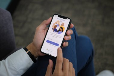 Chiangmai, Thailand - April 06, 2021: A user opens the Microsoft Teams mobile app. Teams is a unified team communication and collaboration platform with workplace chat, video meetings, and file