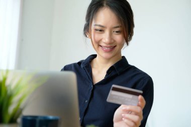 Online payment, Young Womens hands holding credit card and using computer for online shopping at home