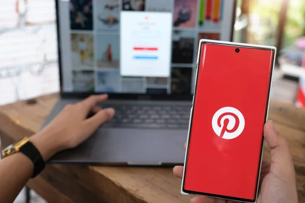 Chiangmai, THAILAND - Haziran 06, 2021: Ekranda Pinterest uygulamalı akıllı telefon taşıyan kadın. Pinterest, insanların ilginç şeylerini iğnelemesini sağlayan çevrimiçi bir pinboard..