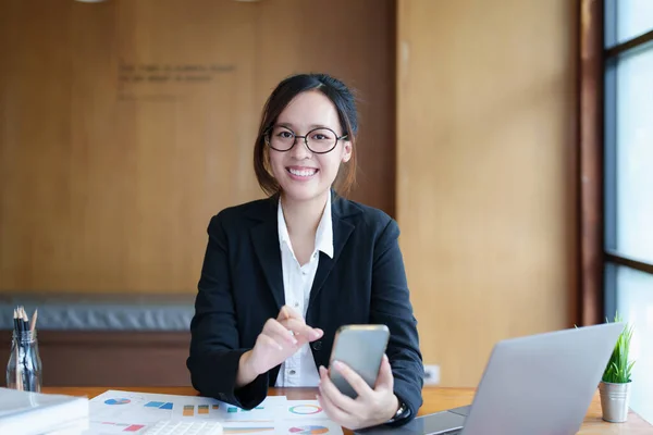 휴대폰 컴퓨터 문서를 책상에 얼굴을 아시아의한 여성의 — 스톡 사진