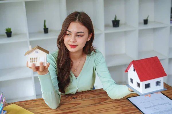 The client select a house model, inspector concept of a home before making a decision to invest, make a loan, get insurance and sign important documents with the bank