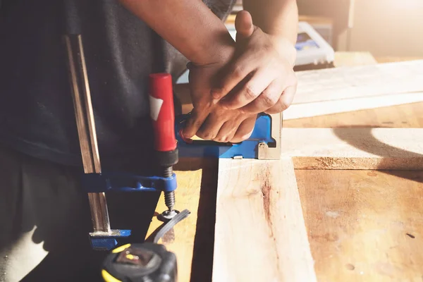 Entrepreneur Woodwork holding a Tacker to assemble the wood pieces as the customer ordered