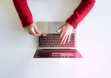 İnternetten alışveriş, internetten alışveriş yaparken kredi kartı tutan kadının fotoğrafı. Kredi kartı, harcama parası, e-ticaret, internet bankacılığı konsepti fotokopi alanı ile beyaza izole edilmiş fotoğraf.