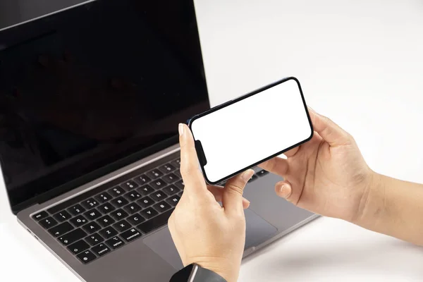 Modern phone mock up, office worker holding modern phone mock up. Close up over shoulder view of woman watching, looking, video calling, attending online meeting concept idea photo with copy space.