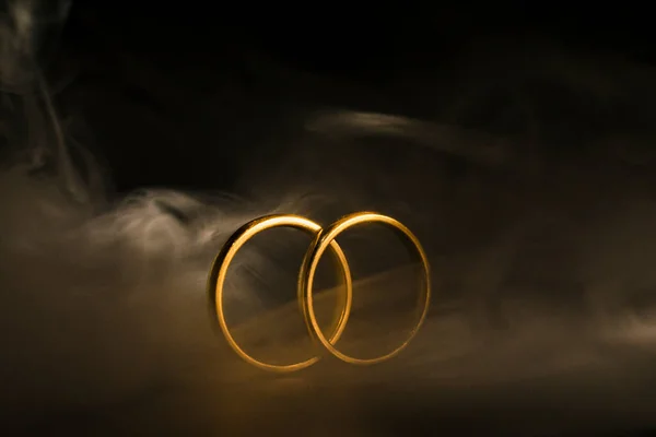 Two gold rings with smoke effect