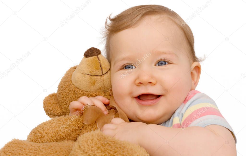 Toddler cuddles the furry teddy bear