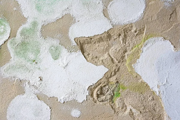 Wall plaster is crumbling from the wall. Damp wall with mold formation