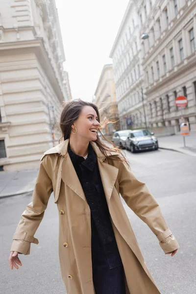 Joyful Young Woman Beige Trench Coat Walking European Street — ストック写真