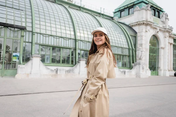 Alegre Joven Mujer Gabardina Gorra Béisbol Pie Con Las Manos — Foto de Stock