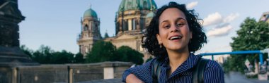 BERLIN, GERMANY - JULY 14, 2020: amazed young woman near blurred berlin cathedral, banner
