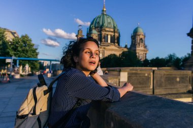 BERLIN, GERMANY - JULY 14, 2020: surprised young woman with open mouth near blurred berlin cathedral clipart