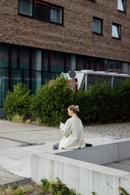 Berlin 'de şehir sokağında cep telefonu kullanan bir kadın 