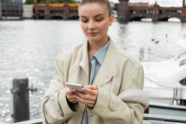 Vrouw Trench Jas Met Behulp Van Mobiele Telefoon Straat Berlijn — Stockfoto