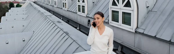 Donna felice che parla sul cellulare sul tetto dell'edificio urbano, striscione — Foto stock