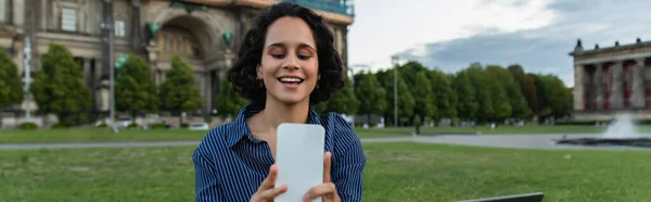 Cheerful woman taking selfie on smartphone near cathedral in berlin, banner — Foto stock