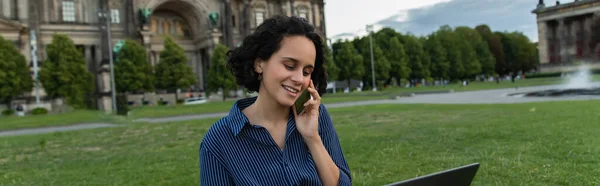 Cheerful woman talking on smartphone near cathedral in berlin, banner — Photo de stock