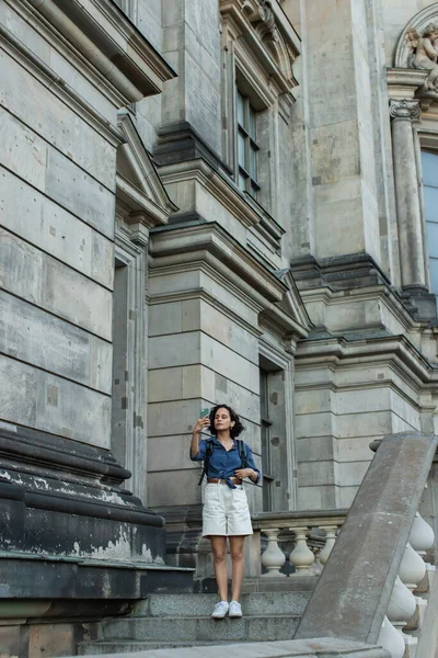 Full length of tourist taking selfie on smartphone in front of building in berlin — Photo de stock