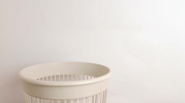 An empty plastic bottle is thrown away in a landfill for disposal and recycling